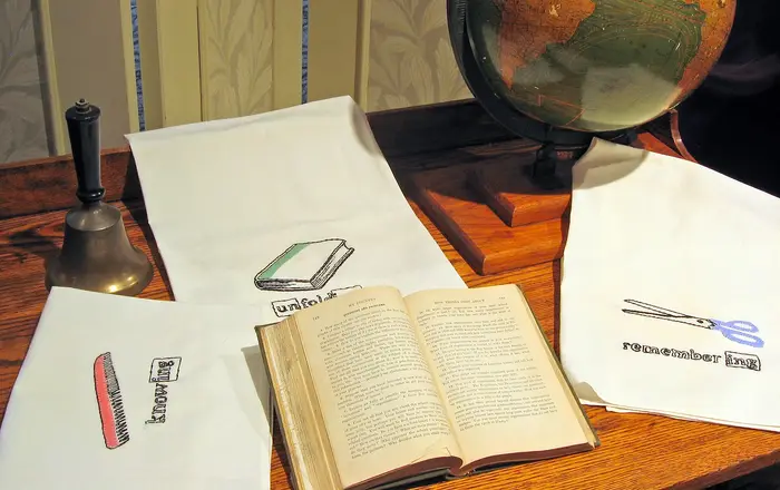 Globe and desk   needlework on display at Stevens County Museum